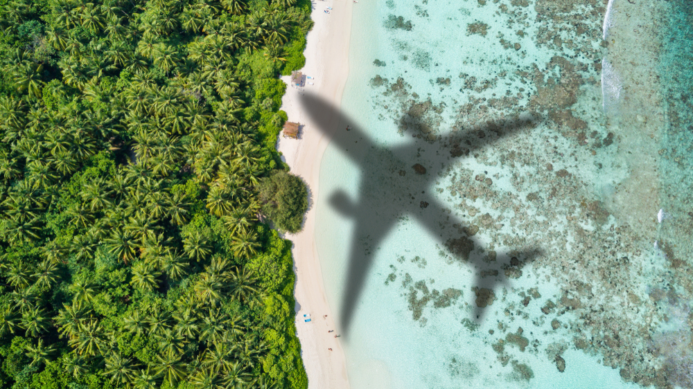 Concept,Of,Airplane,Travel,To,Exotic,Destination,With,Shadow,Of